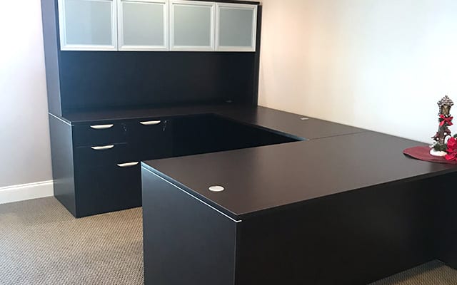 used black u-shaped desk with hutch